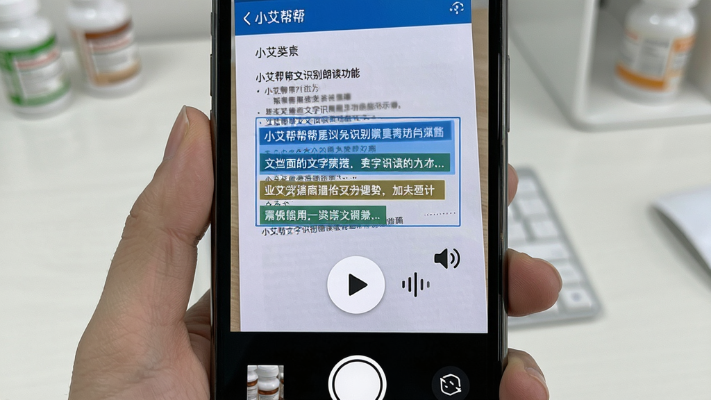 小艾帮帮文字识别朗读功能展示图,画面中手机摄像头对准一张药品说明书,屏幕上识别出的文字段落被高亮框选,旁边有播放按钮和音量波形图标,布局居中展示,风格简洁科技感,细节清晰,画质干净无多余元素