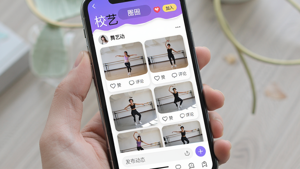 一张展示“校艺”App兴趣圈子功能的图片,画面主体是手机屏幕,屏幕中显示“校艺”的舞蹈圈子页面,顶部有圈子名称和加入按钮,中间是圈子成员发布的舞蹈练习视频和图片卡片,每个卡片下方有点赞和评论按钮,底部有发布动态的输入框,整体布局清晰,风格活泼,细节精致,画质干净,无多余元素